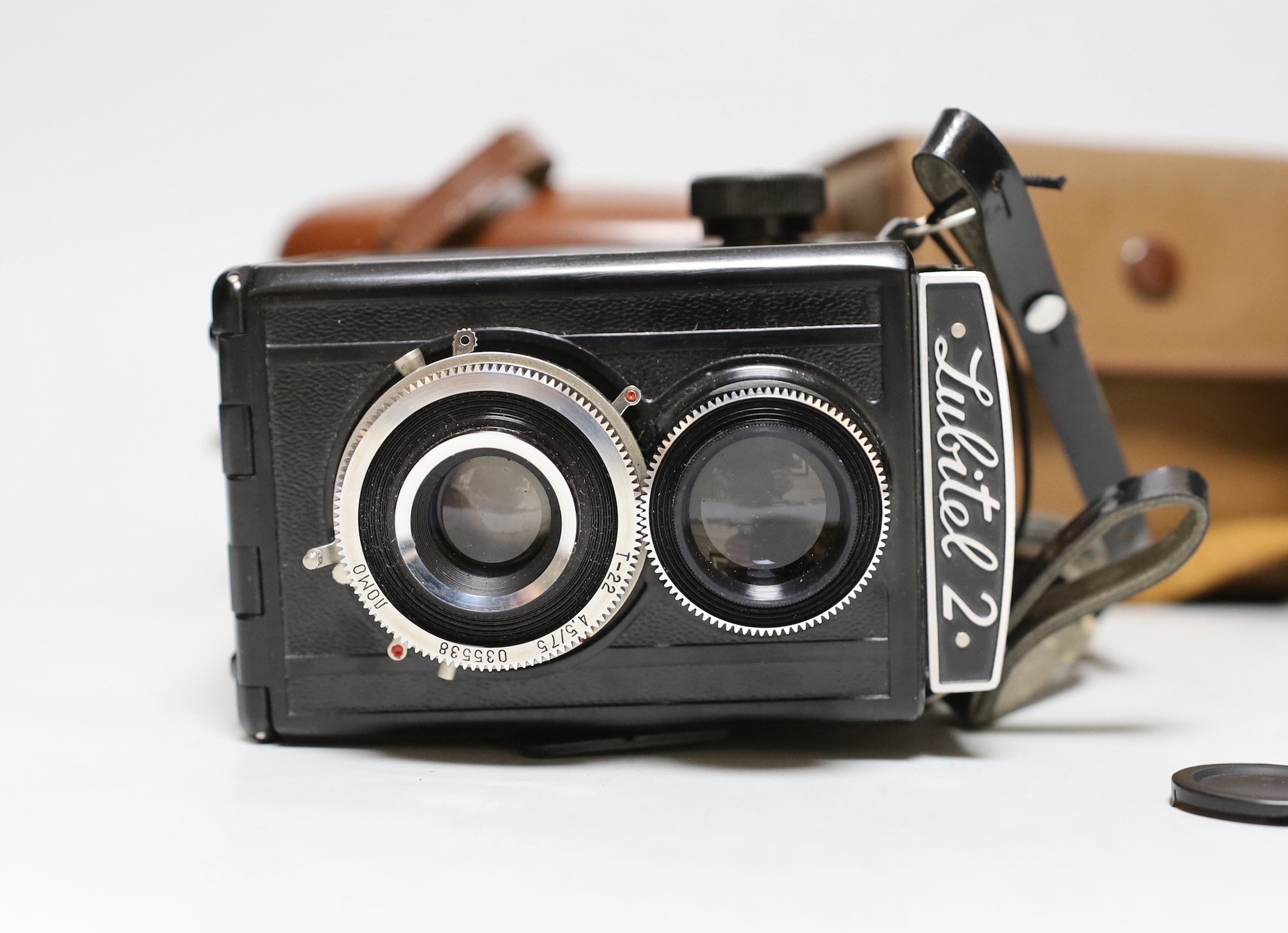 Three cameras, two cased plus a flash and light meter